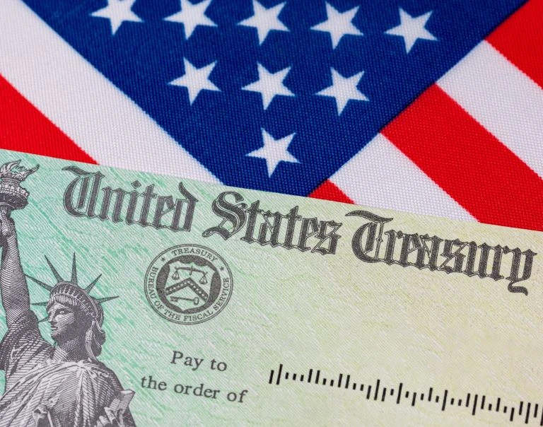 U.S. Treasury check laid over an American flag